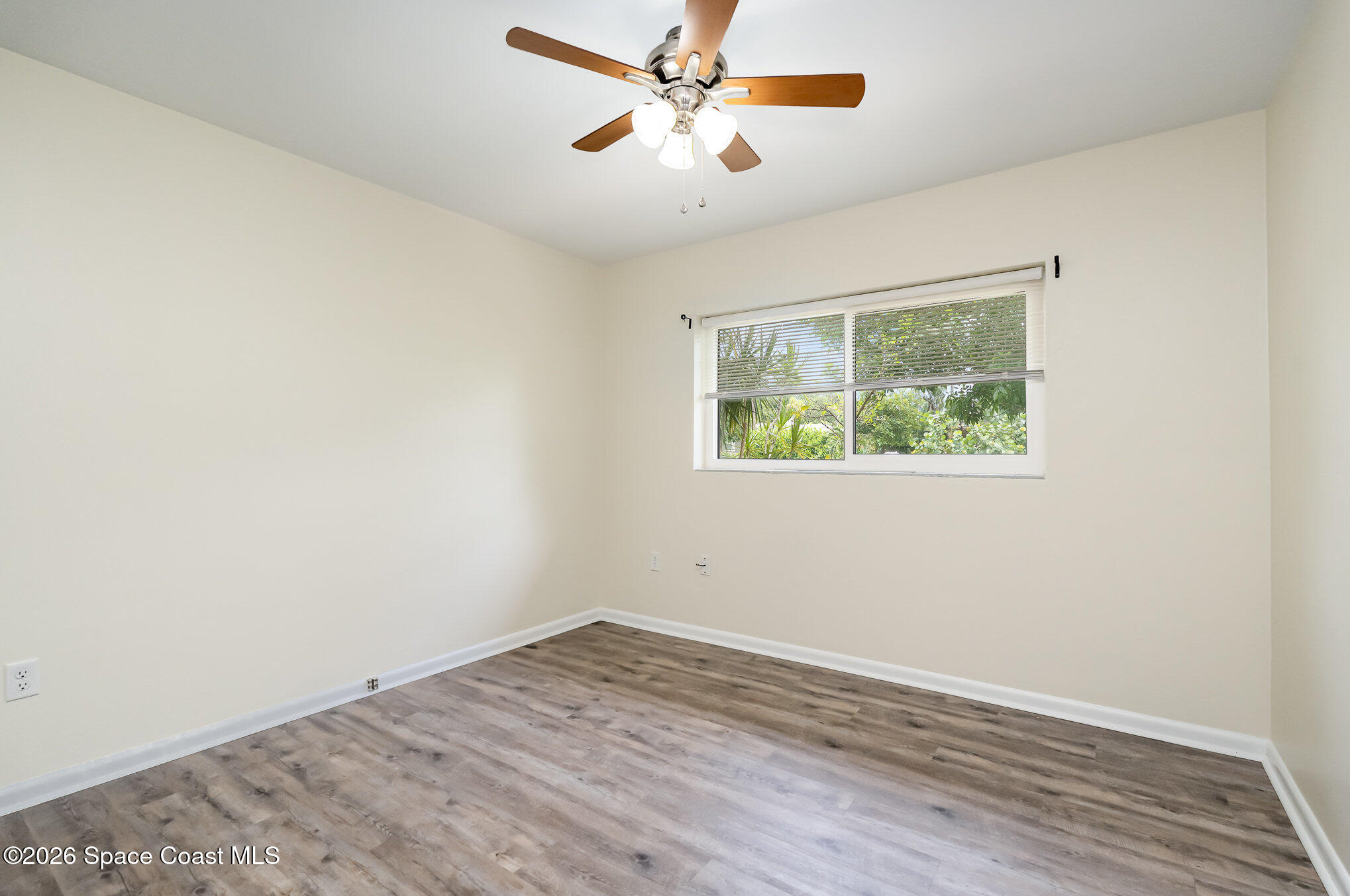 115 Gary Lane Cocoa, FL 32922 - Photo 11 of 29 an empty room with a window and a ceiling fan