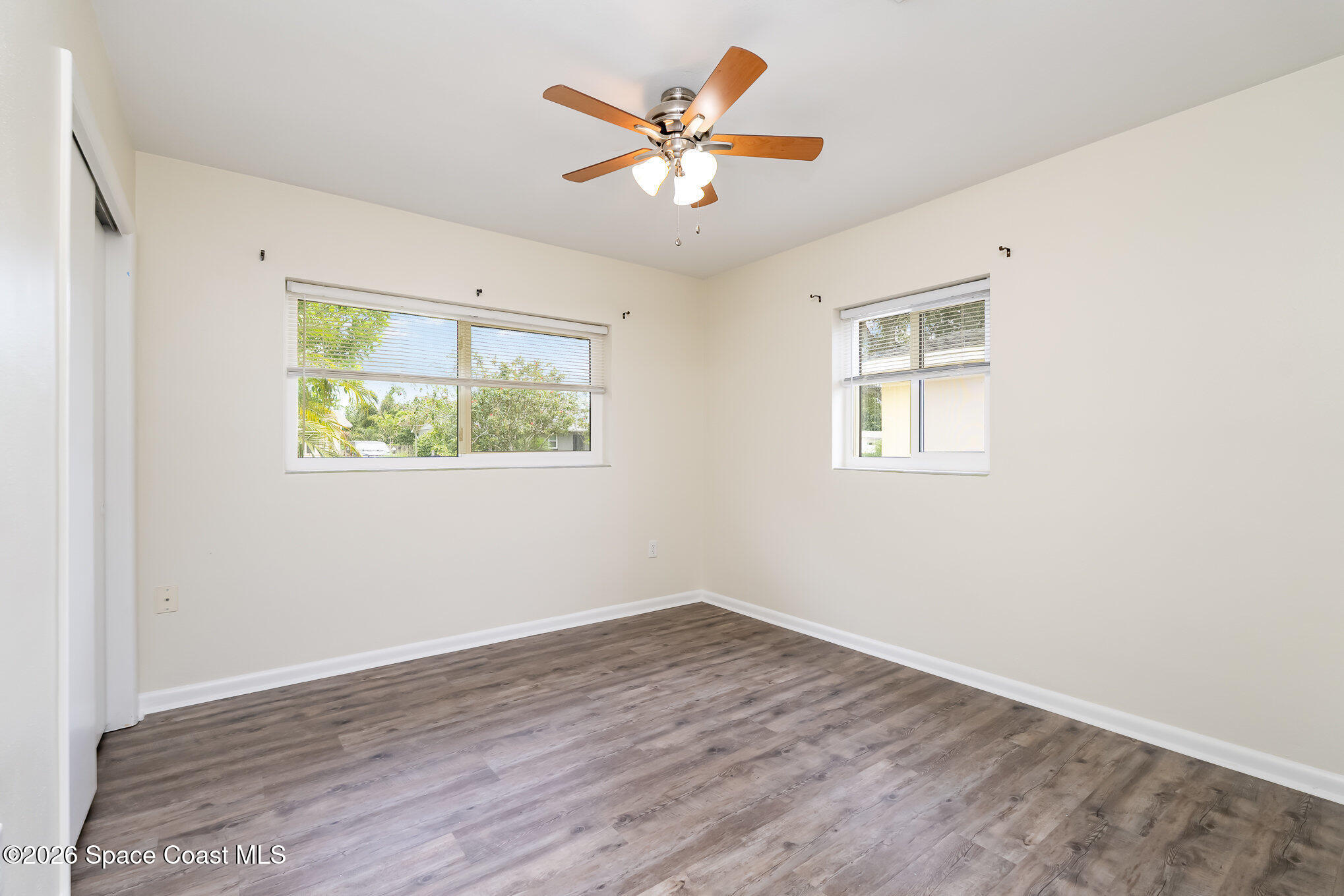 115 Gary Lane Cocoa, FL 32922 - Photo 13 of 29 an empty room with wooden floor and window