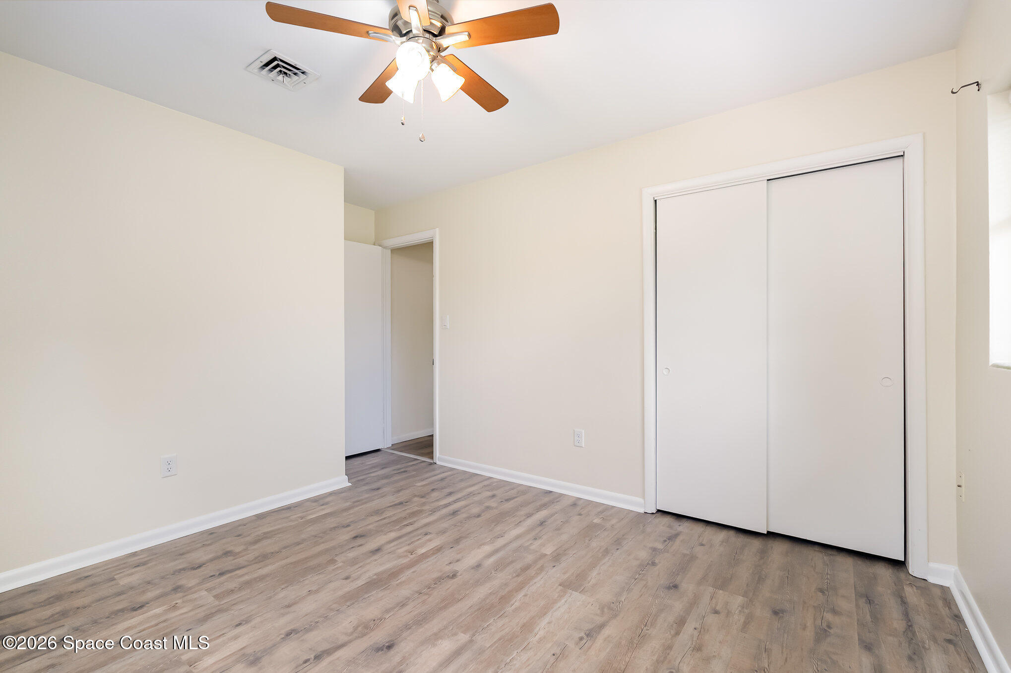 115 Gary Lane Cocoa, FL 32922 - Photo 14 of 29 a view of an empty room with wooden floor