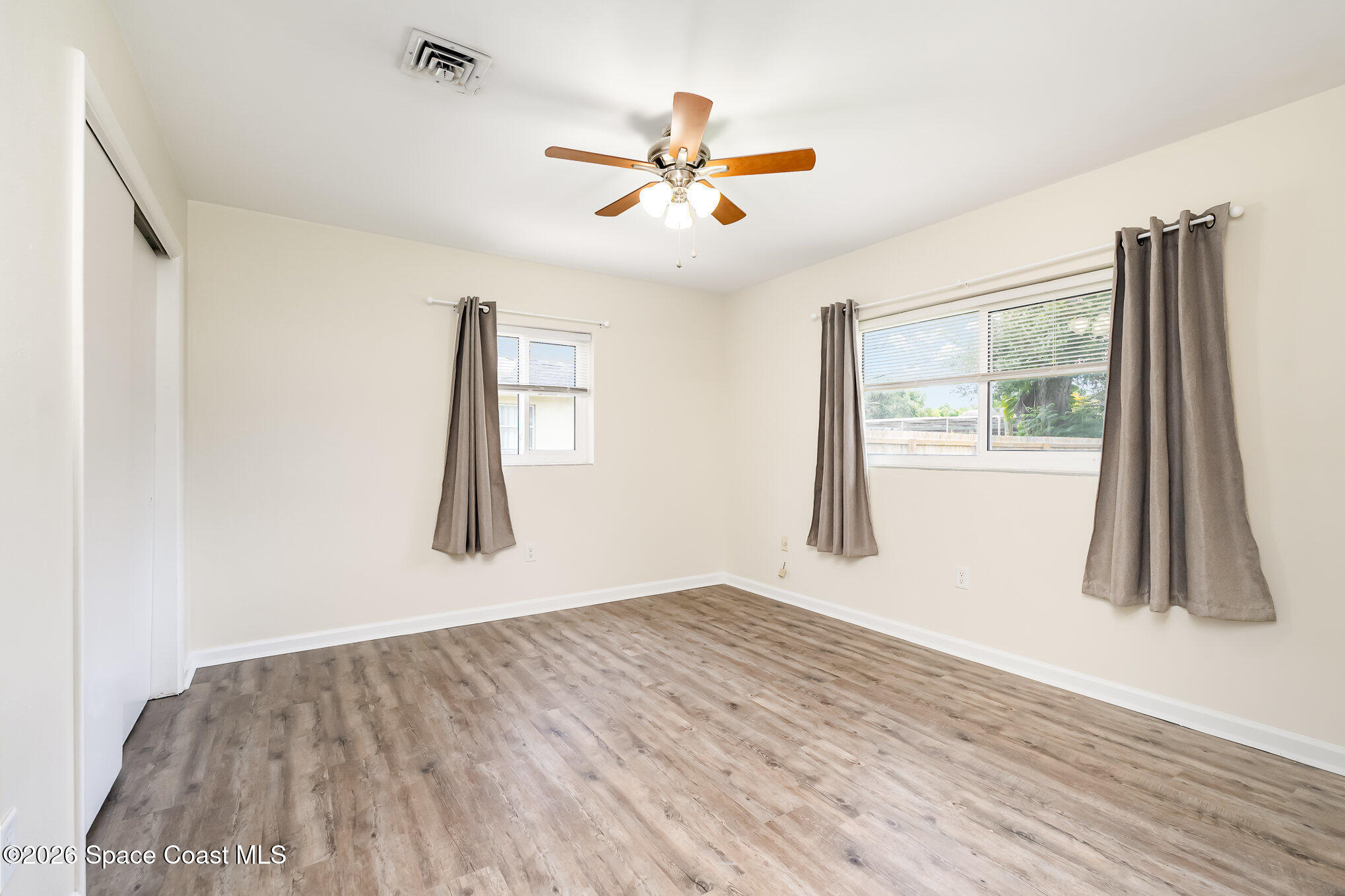 115 Gary Lane Cocoa, FL 32922 - Photo 15 of 29 wooden floor in an empty room with a window