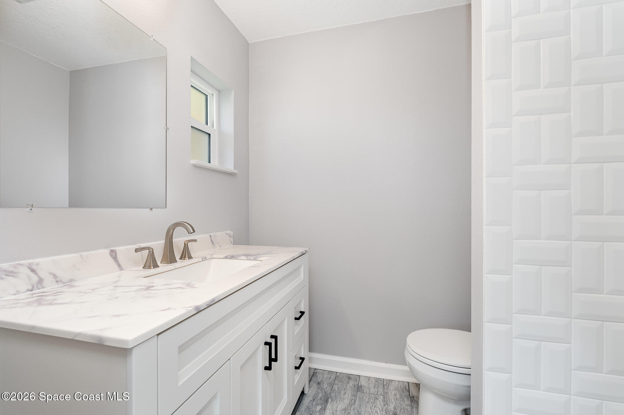 115 Gary Lane Cocoa, FL 32922 - Photo 18 of 29 a bathroom with a sink toilet and a mirror