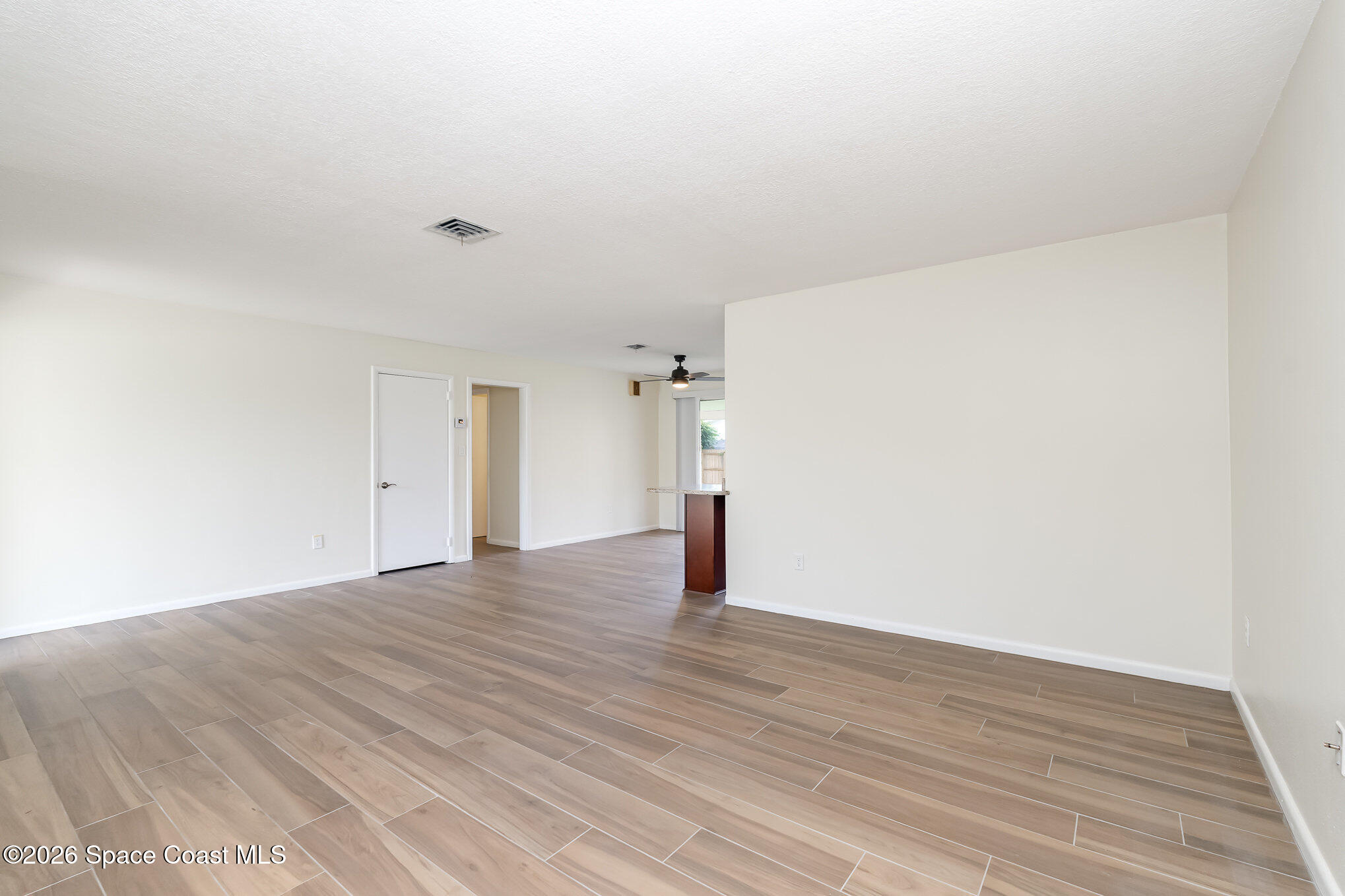 115 Gary Lane Cocoa, FL 32922 - Photo 4 of 29 a view of empty room with wooden floor