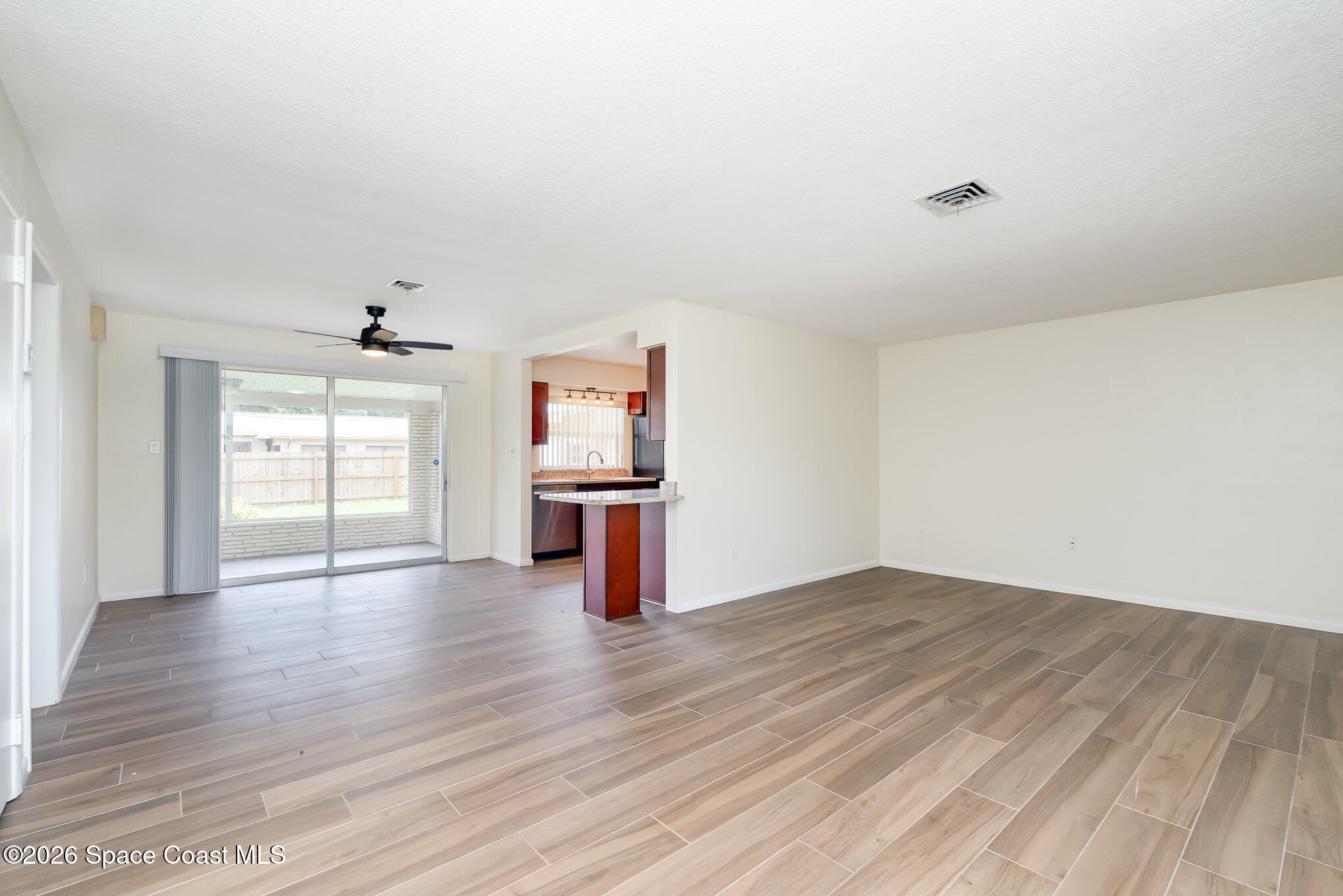 115 Gary Lane Cocoa, FL 32922 - Photo 5 of 29 wooden floor in an empty room with a window