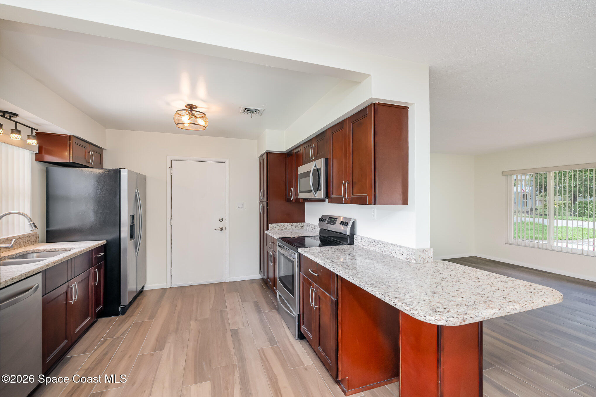115 Gary Lane Cocoa, FL 32922 - Photo 8 of 29 a kitchen with a sink stove and refrigerator