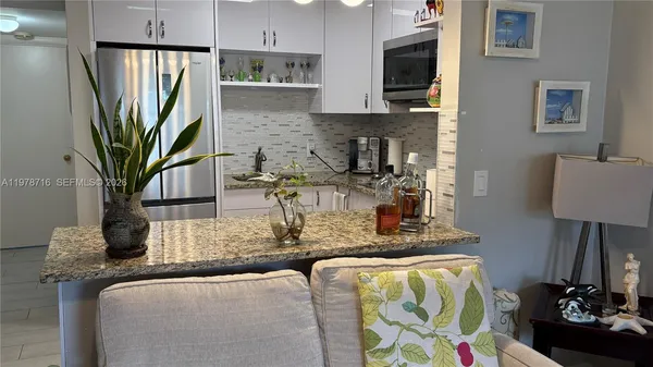 a view of living room with furniture and a flat screen tv