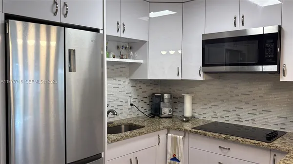 a kitchen with stainless steel appliances white cabinets and a stove