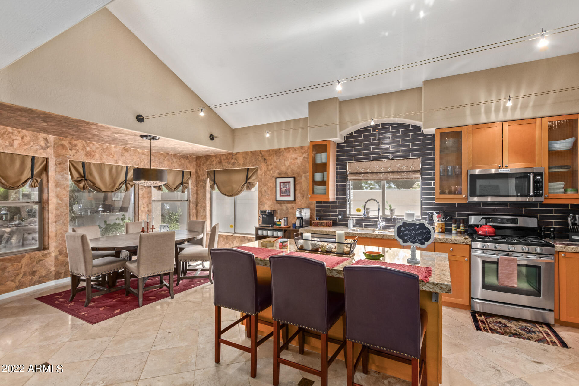 625 West Ocotillo Road Phoenix, AZ 85013 - Photo 19 of 55 a dining hall with stainless steel appliances a table and chairs with the kitchen view