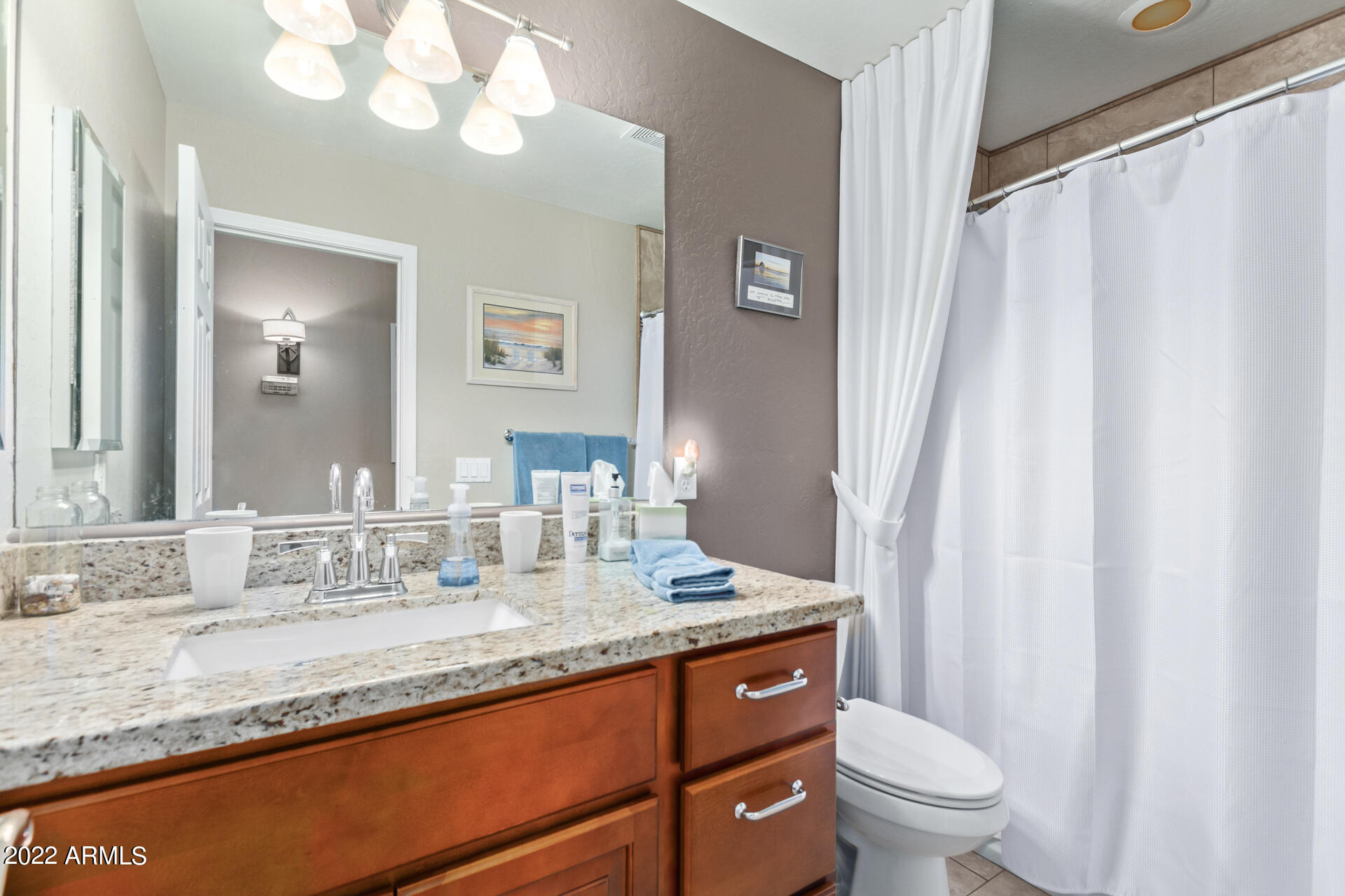 625 West Ocotillo Road Phoenix, AZ 85013 - Photo 33 of 55 a bathroom with a granite countertop sink toilet and a mirror