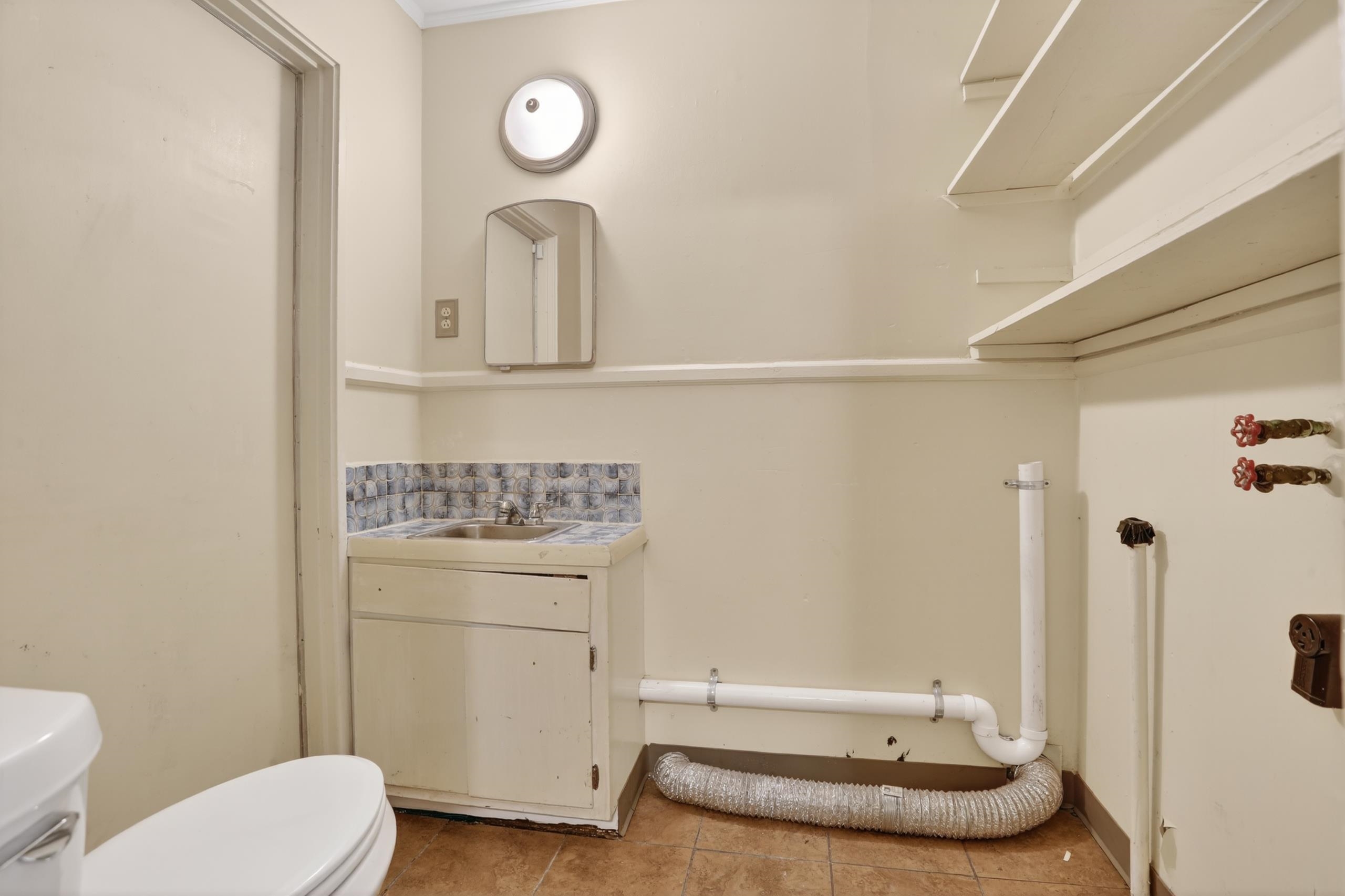 4924 Verne Road Memphis, TN 38117 - Photo 12 of 19 Half bath featuring vanity and light tile patterned floors