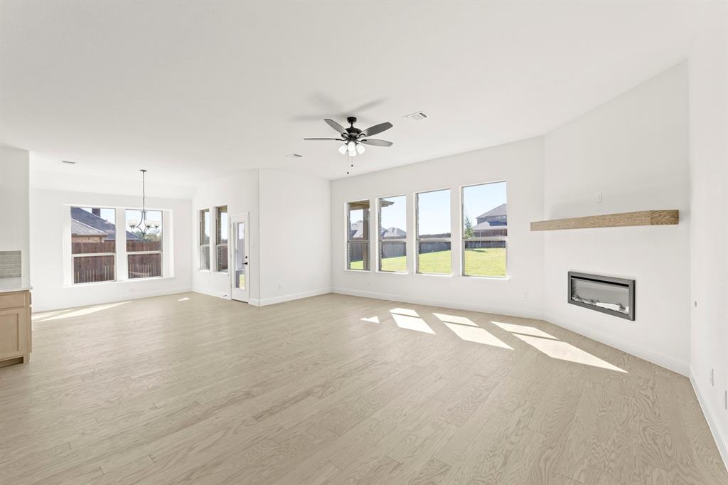 610 Tenor Drive Forney, TX 75126 - Photo 9 of 30 a view of an empty room with a window and a kitchen