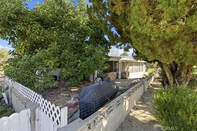 a view of a house with wooden fence