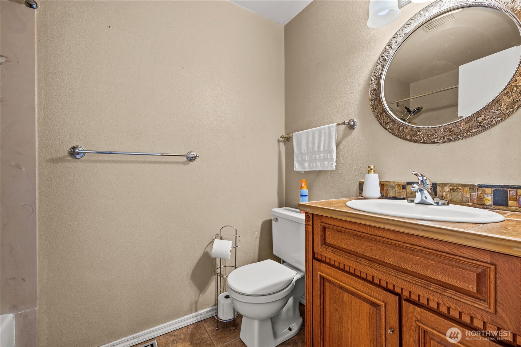 1601 Olympia Avenue Southeast Renton, WA 98058 - Photo 11 of 28 a bathroom with a granite countertop toilet sink and mirror