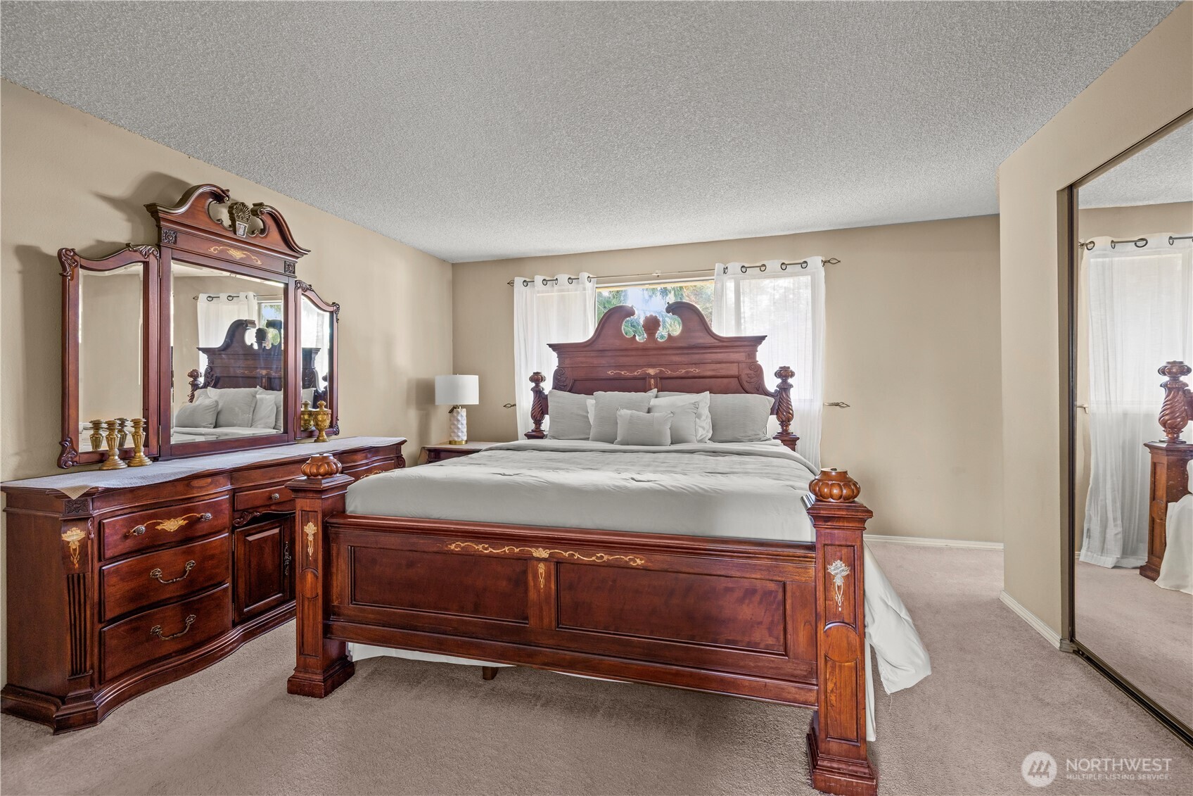 1601 Olympia Avenue Southeast Renton, WA 98058 - Photo 15 of 28 a bedroom with a bed and a mirror on dresser