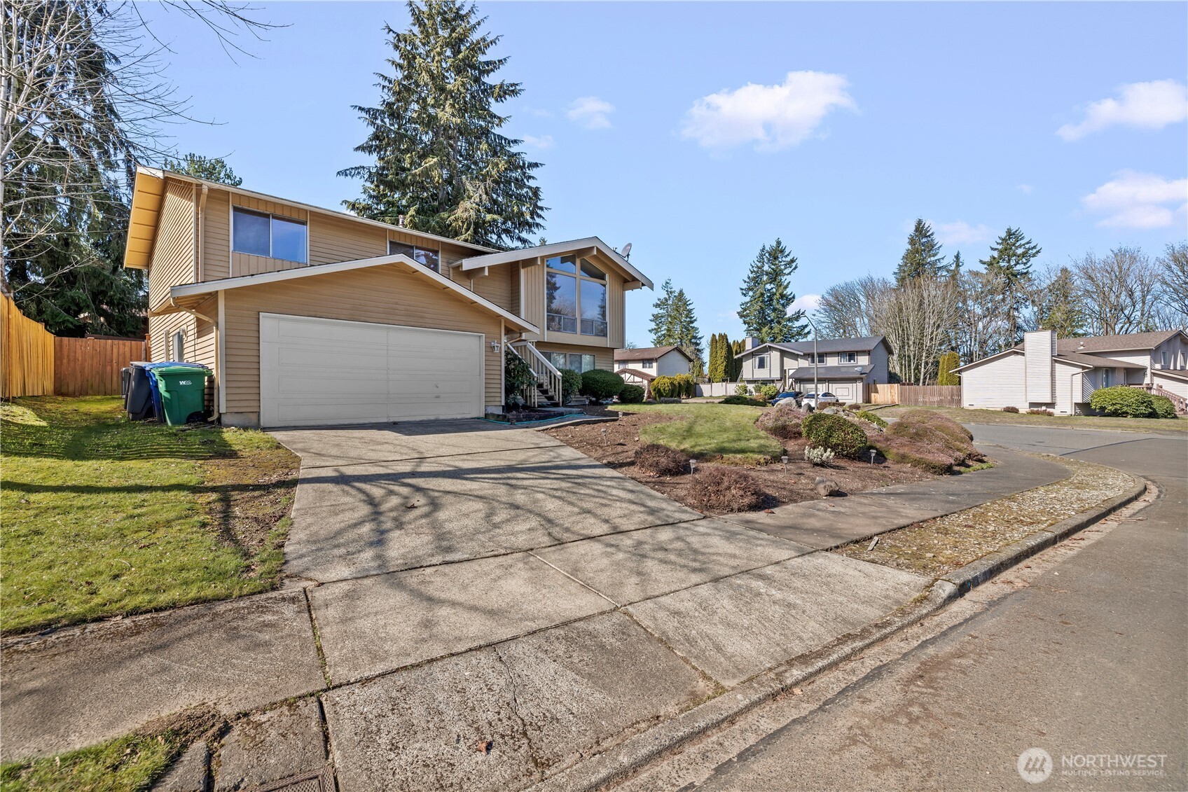 1601 Olympia Avenue Southeast Renton, WA 98058 - Photo 2 of 28 a view of a white house with a yard and road