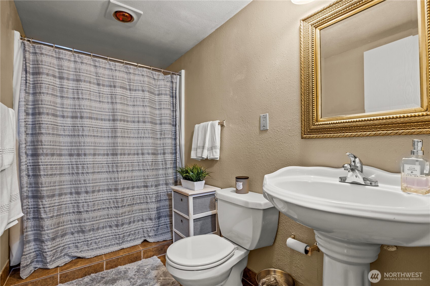 1601 Olympia Avenue Southeast Renton, WA 98058 - Photo 21 of 28 a bathroom with a sink a toilet and shower