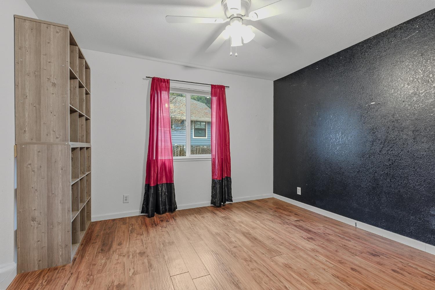5855 Pine Street Foresthill, CA 95631 - Photo 18 of 32 a view of empty room with wooden floor and fan