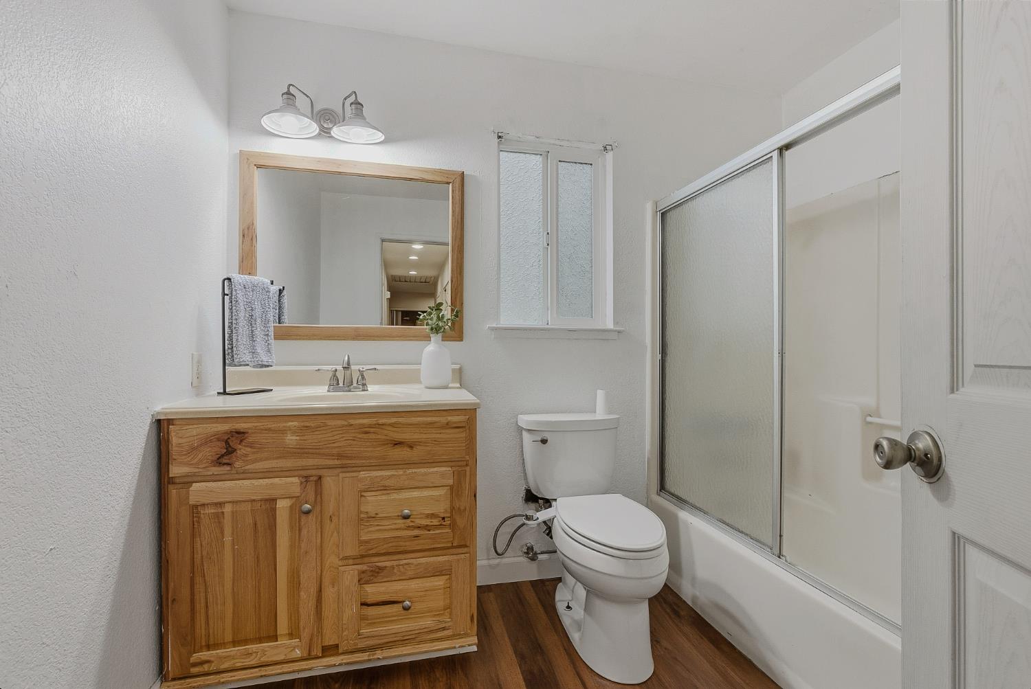 5855 Pine Street Foresthill, CA 95631 - Photo 19 of 32 a bathroom with a granite countertop toilet a sink and a mirror