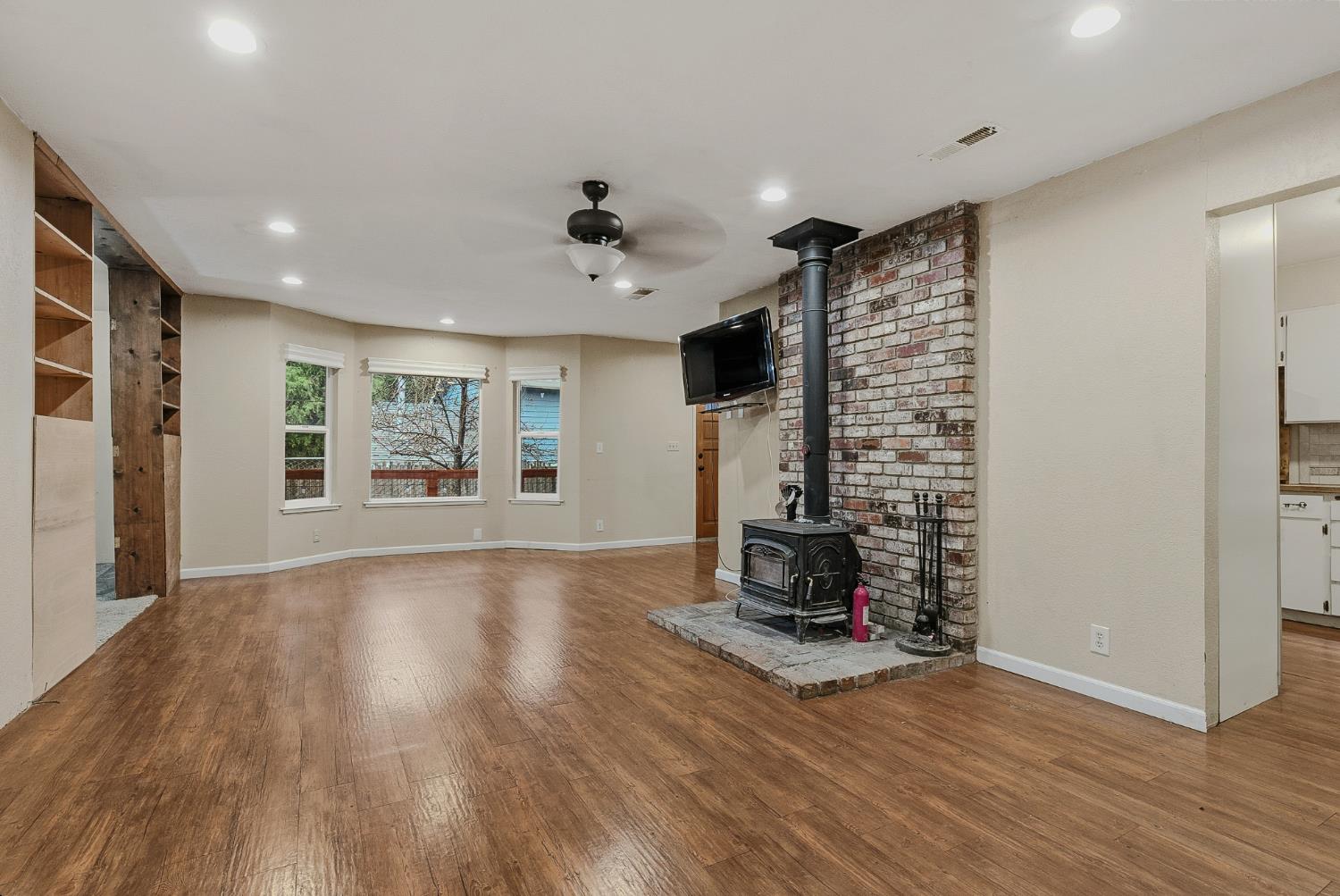 5855 Pine Street Foresthill, CA 95631 - Photo 8 of 32 a view of an empty room with a fireplace and a window