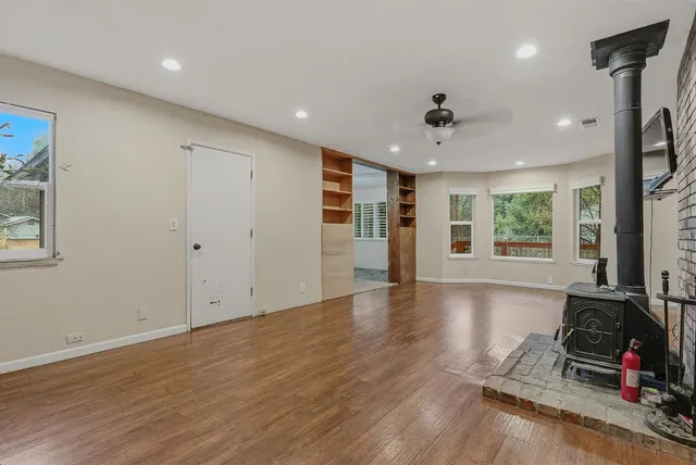 a view of a work space with wooden floor and a window