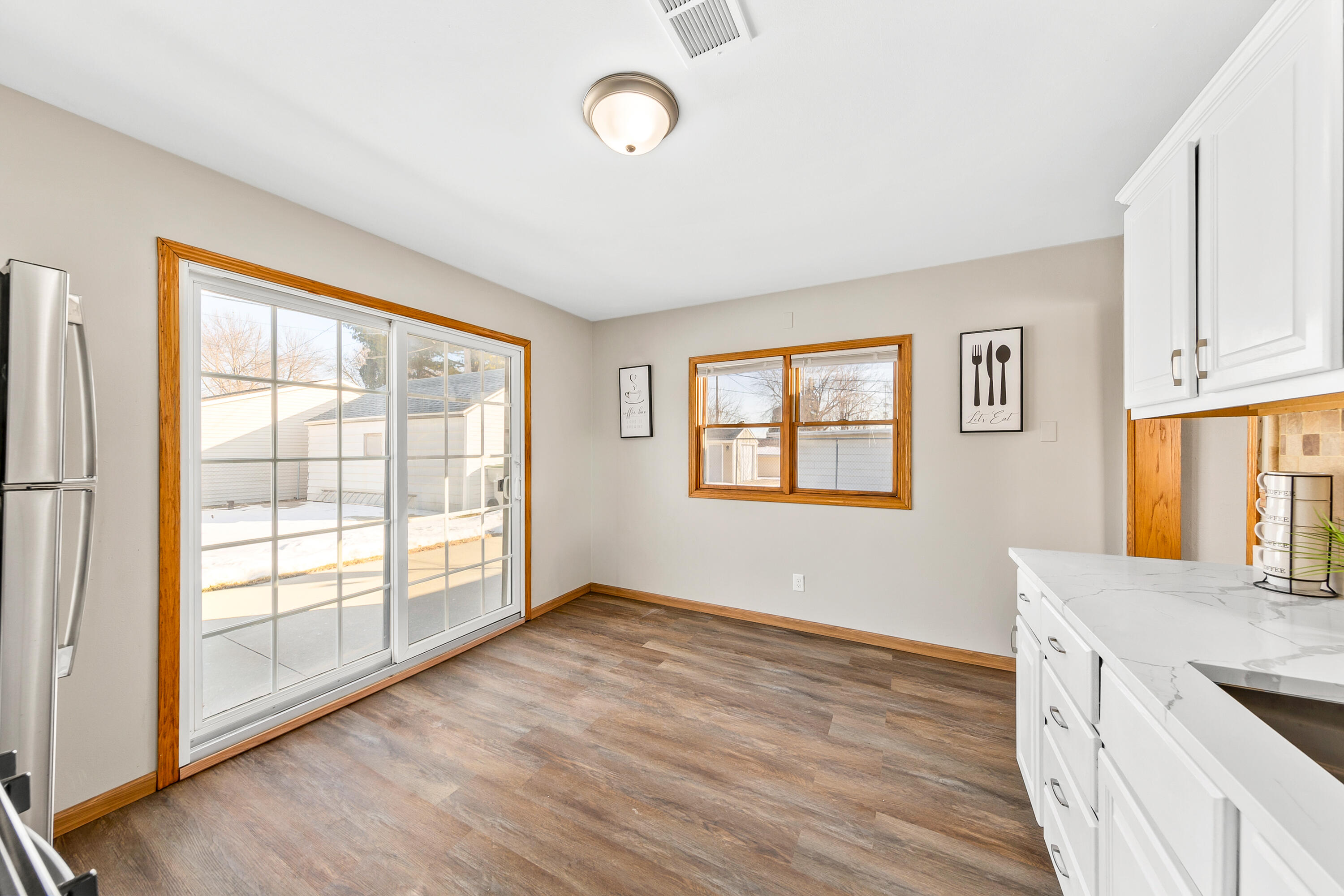 6136 West Oklahoma Avenue Milwaukee, WI 53219 - Photo 10 of 25 Slider in Kitchen opens to patio in the fenced backyard