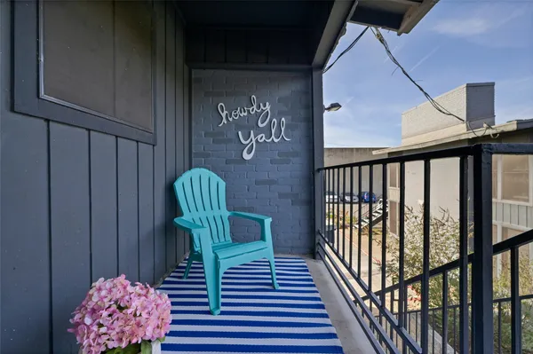 a balcony view with a seating space