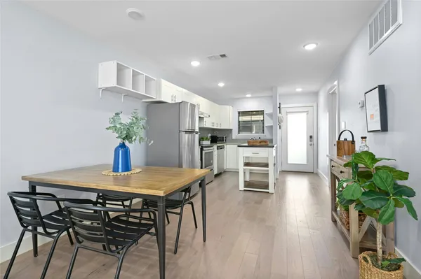 a view of a dining room with furniture and wooden floor