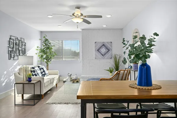 a living room with furniture flowerpot and window