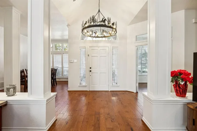 an entryway with wooden floor and cabinet