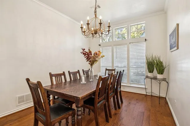 a view of a dining room with furniture and chandelier