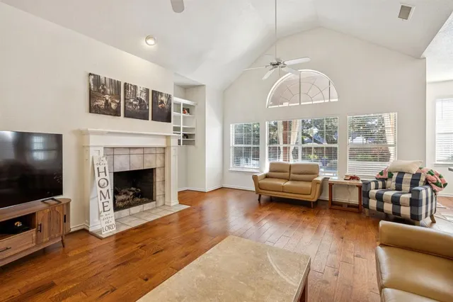 a living room with furniture a flat screen tv and a fireplace
