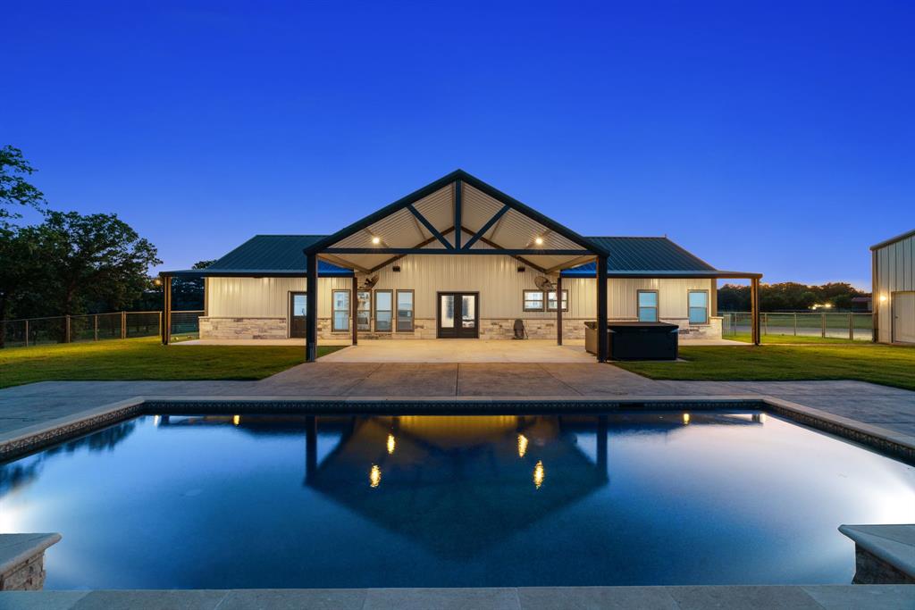 a front view of a house with swimming pool yard and outdoor seating