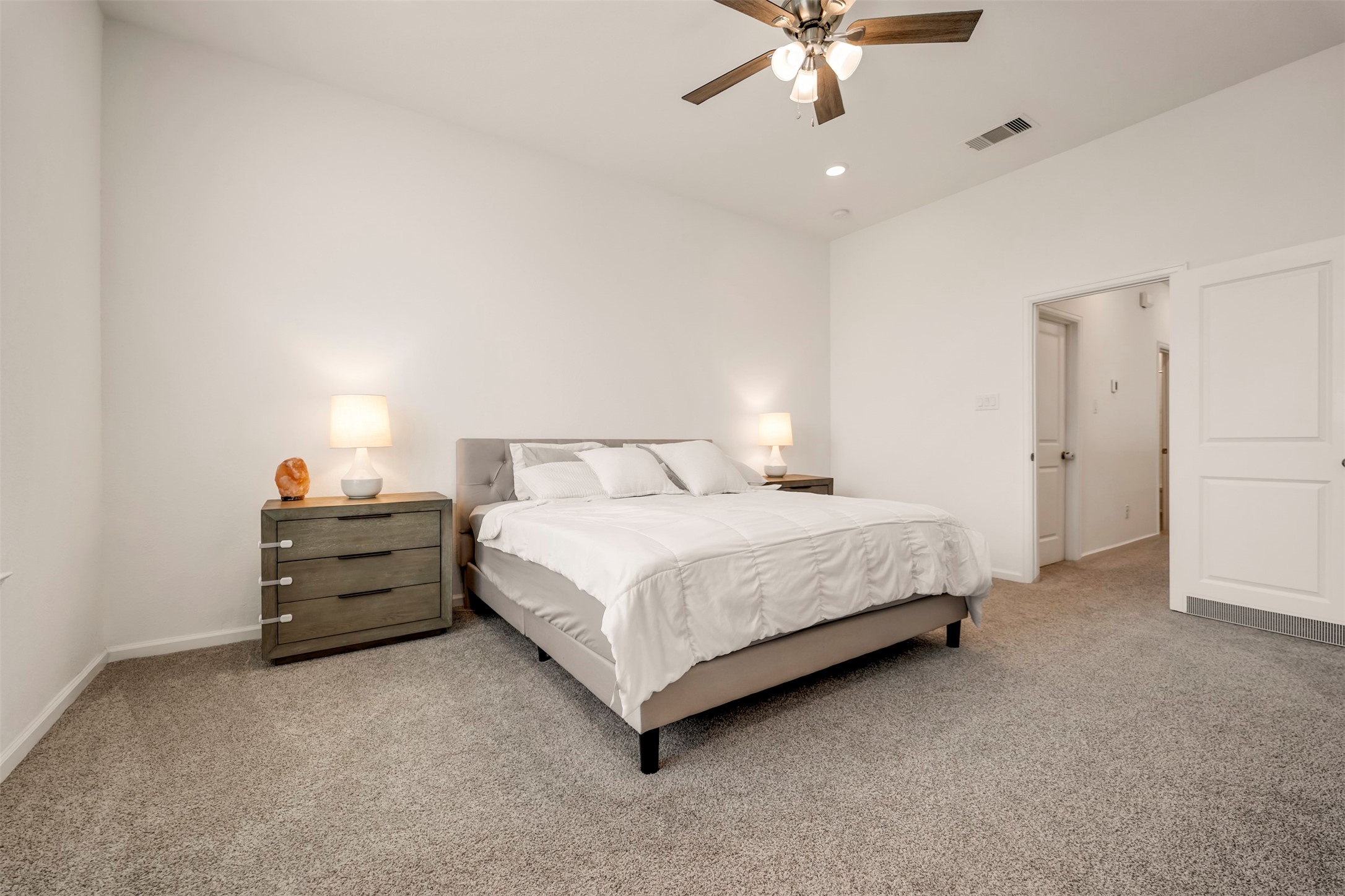 4127 Champlain Way Iowa Colony, TX 77583 - Photo 20 of 35 a spacious bedroom with a bed and a ceiling fan