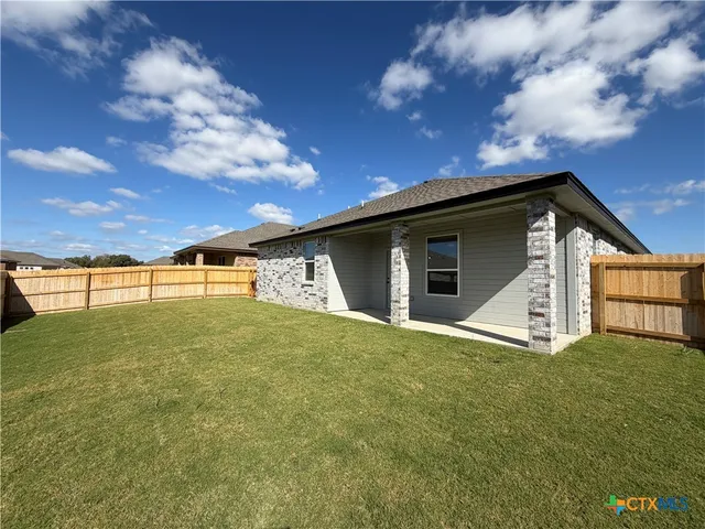 a view of a backyard of the house