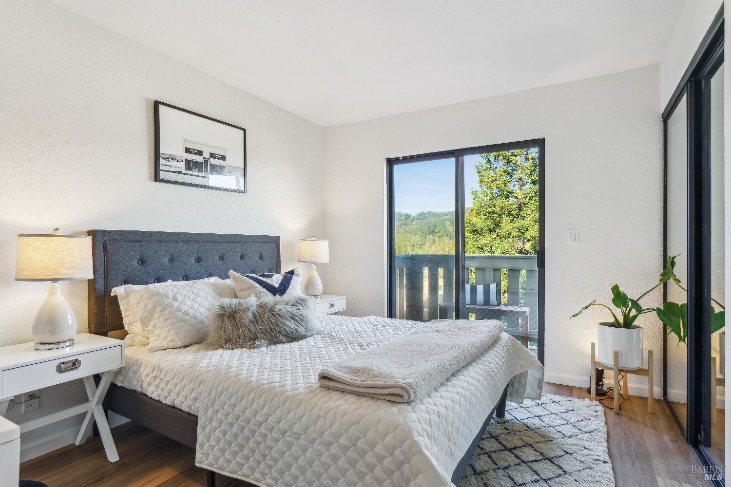 134 Redhawk Road Novato, CA 94949 - Photo 16 of 18 a bedroom with a large bed and a potted plant