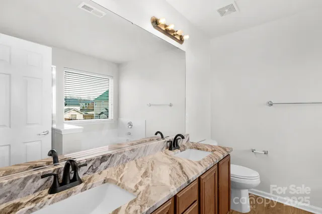 a bathroom with a sink toilet and a tub