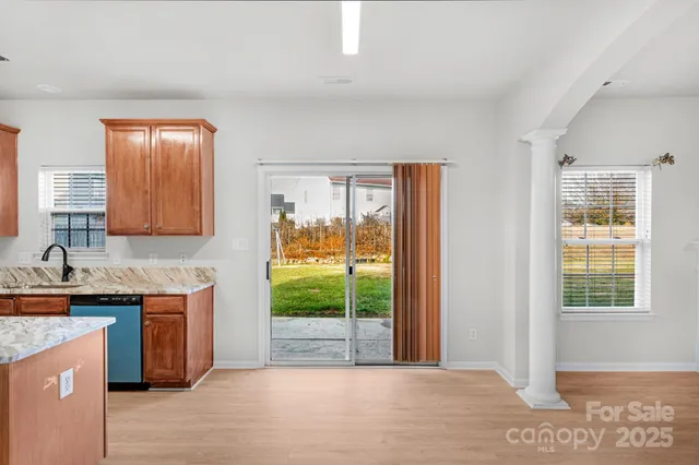 a view of a kitchen with a sink and a window
