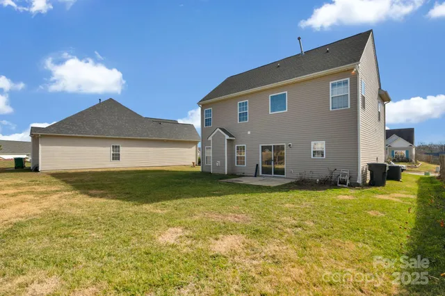 a house view with swimming pool in front of it