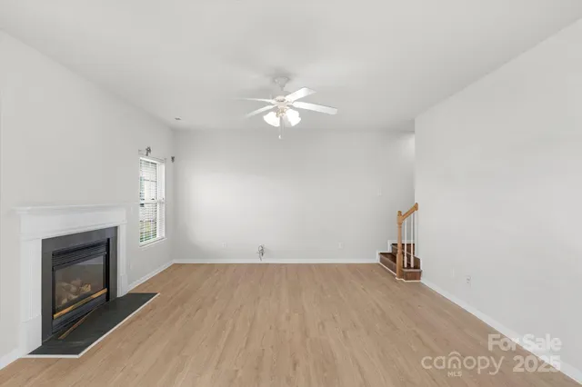 wooden floor in an empty room with a fireplace