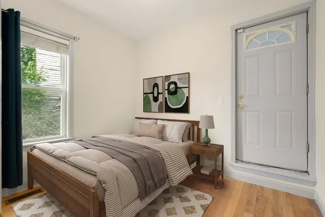 a bedroom with a bed and a window