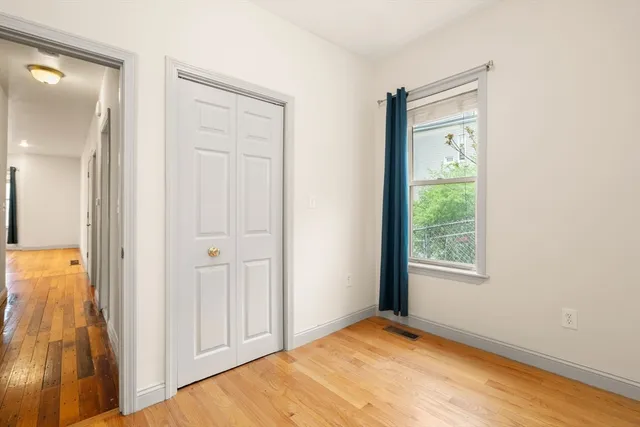 an empty room with windows and closet