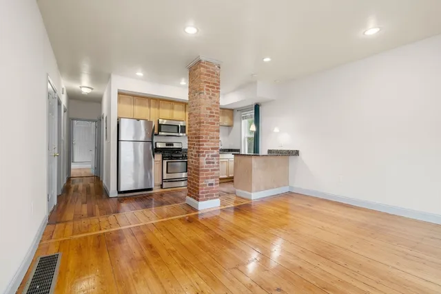 a view of a kitchen with furniture and an empty room