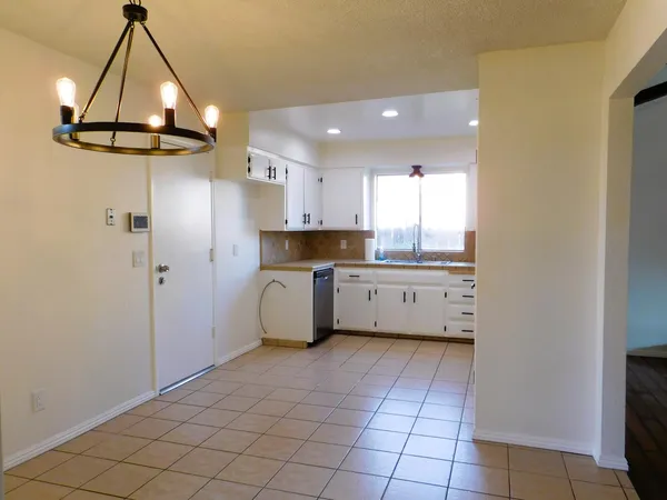 a kitchen with stainless steel appliances a refrigerator sink and cabinets