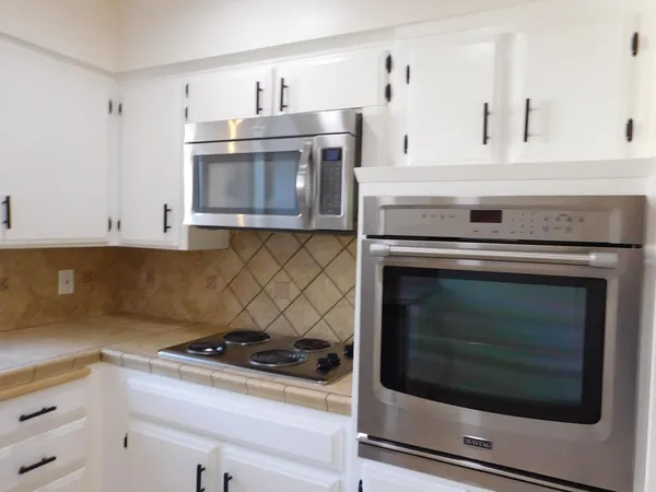 a stove top oven sitting inside of a kitchen