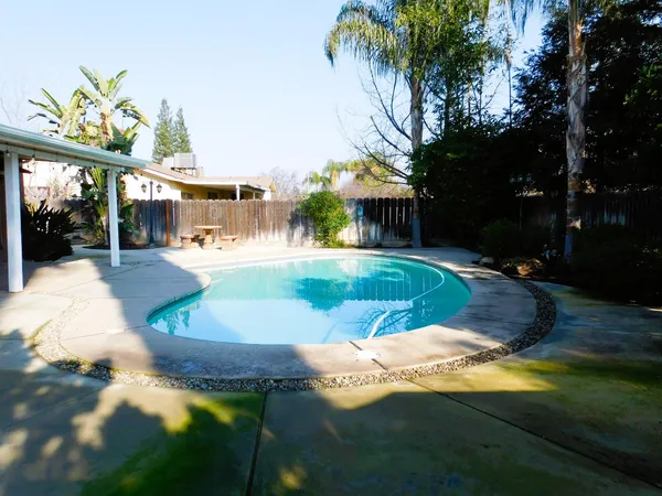 a view of a swimming pool with an outdoor space and seating area