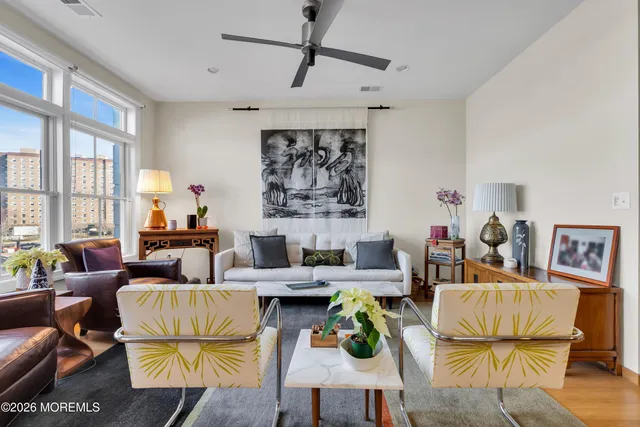 a living room with furniture and wooden floor