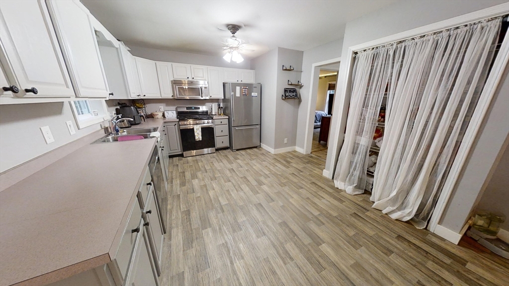 476 Worcester Road Barre, MA 01005 - Photo 8 of 30 a kitchen with stainless steel appliances a refrigerator and wooden floor