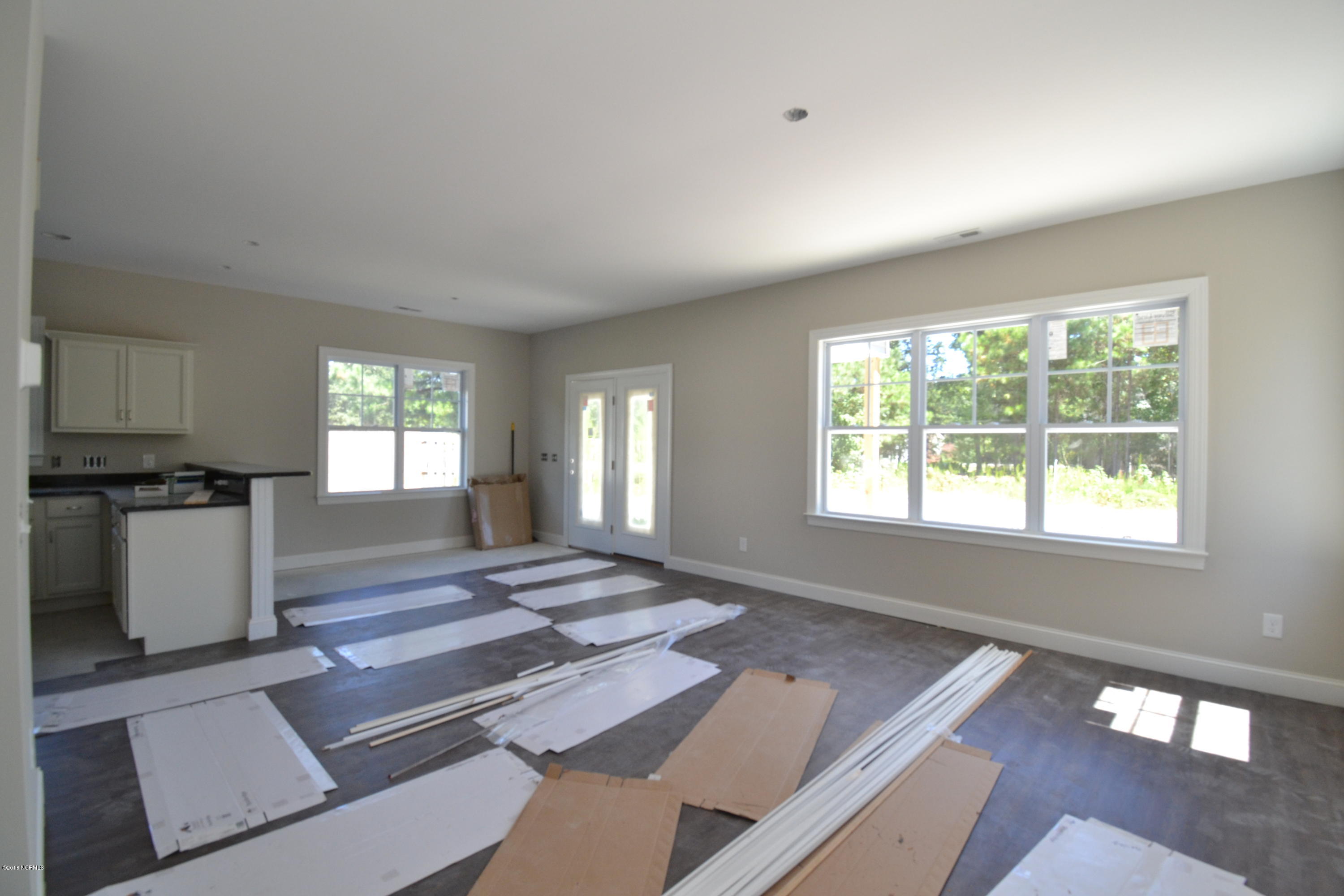 894 Hoover Road Hampstead, NC 28443 - Photo 7 of 16 Large open living room flows nicely into the kitchen and dining area