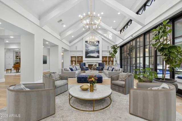 a kitchen with kitchen island stainless steel appliances a sink and chairs