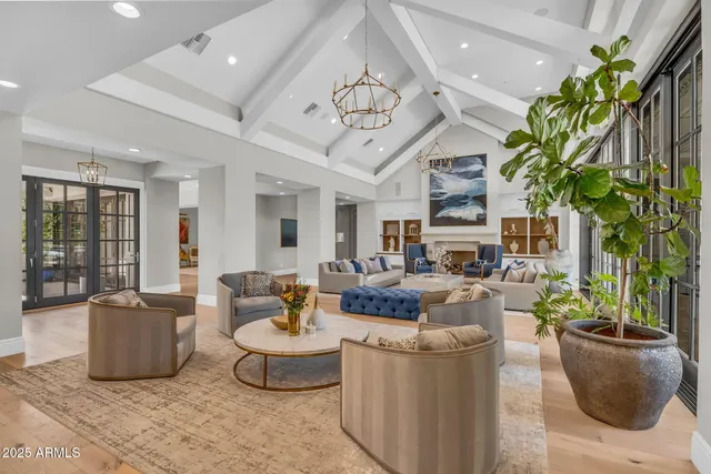 a kitchen with stainless steel appliances granite countertop a dining table chairs and granite counter tops