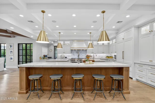 a kitchen with a stove and a wooden floor